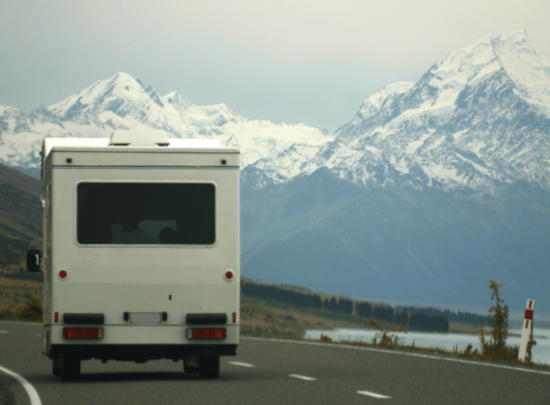 rear view of a motorhome travelling a snowy new zealand road